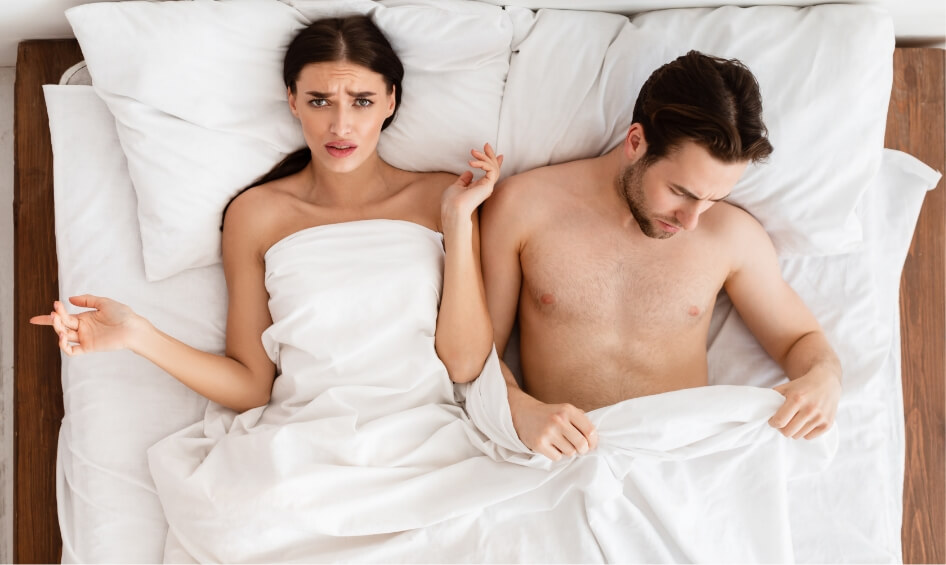 displeased-girlfriend-lying-near-boyfriend-with-er-2023-11-27-05-24-41-utc-1